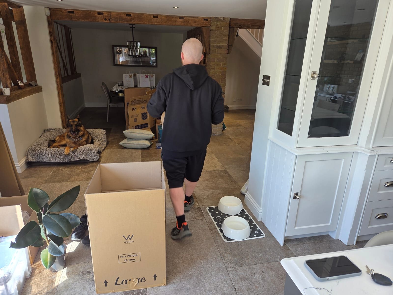 Open moving boxes and household belongings inside a home.