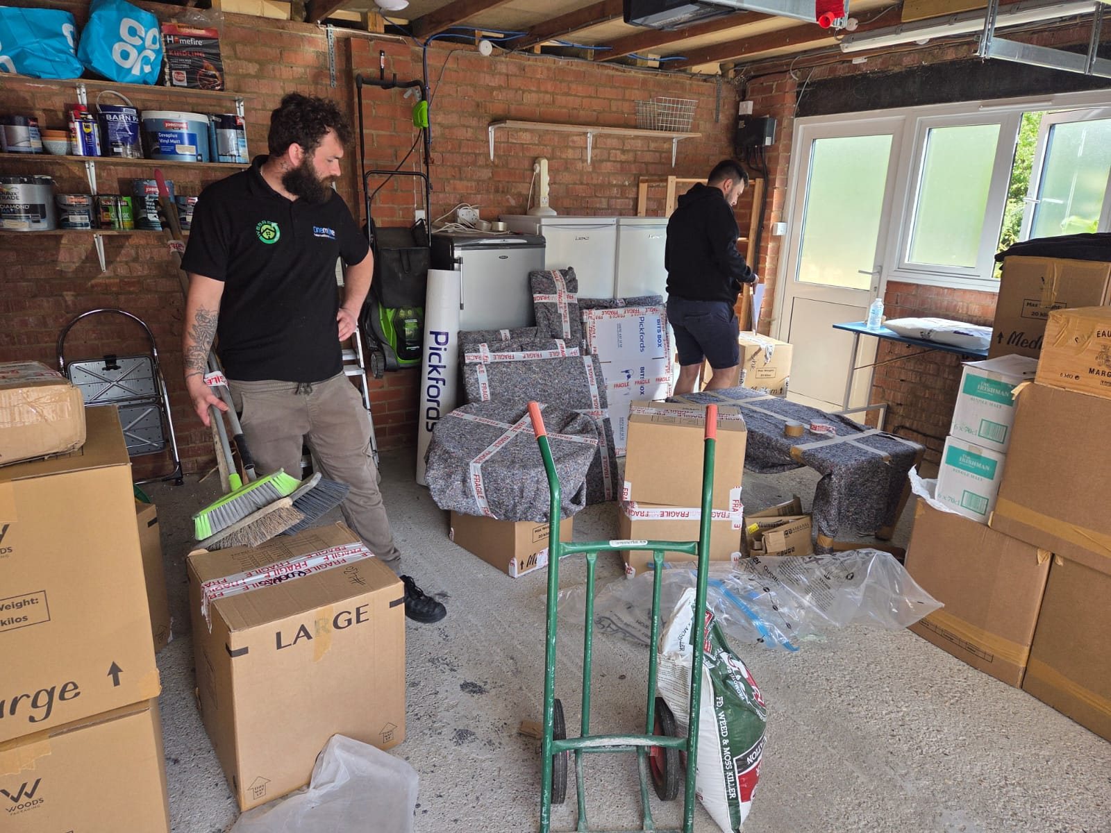 Preparing a collection area with packed boxes and protected household items.